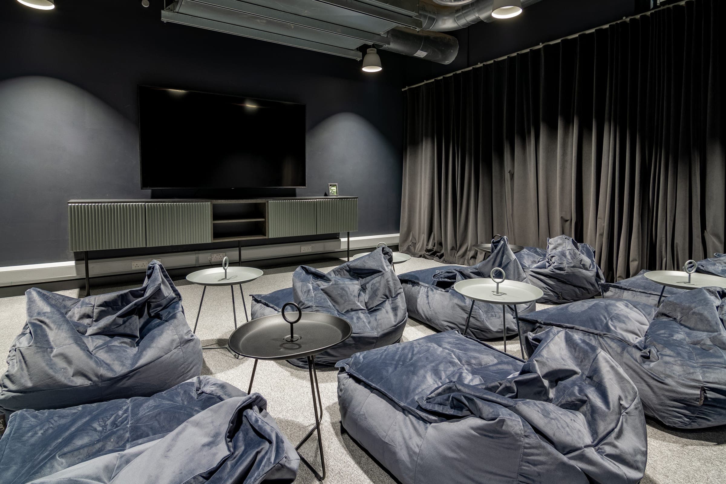 Cinema room at Globe Works with beanbag seating facing a wall-mounted screen