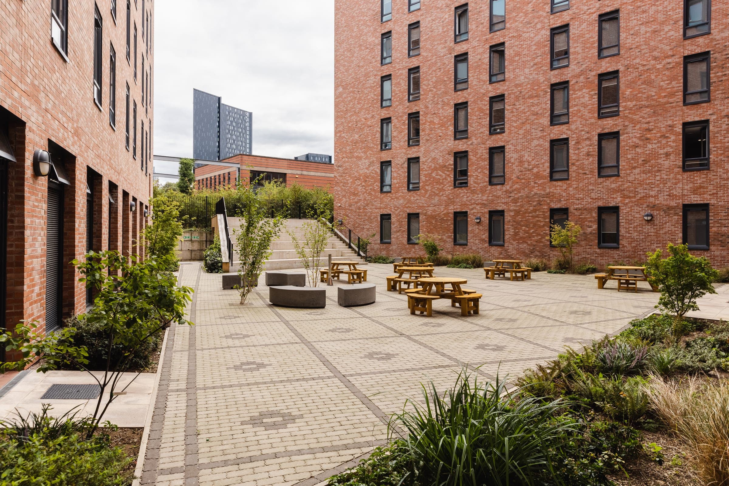 The enclosed courtyard at Globe Works, with picnic benches and planting