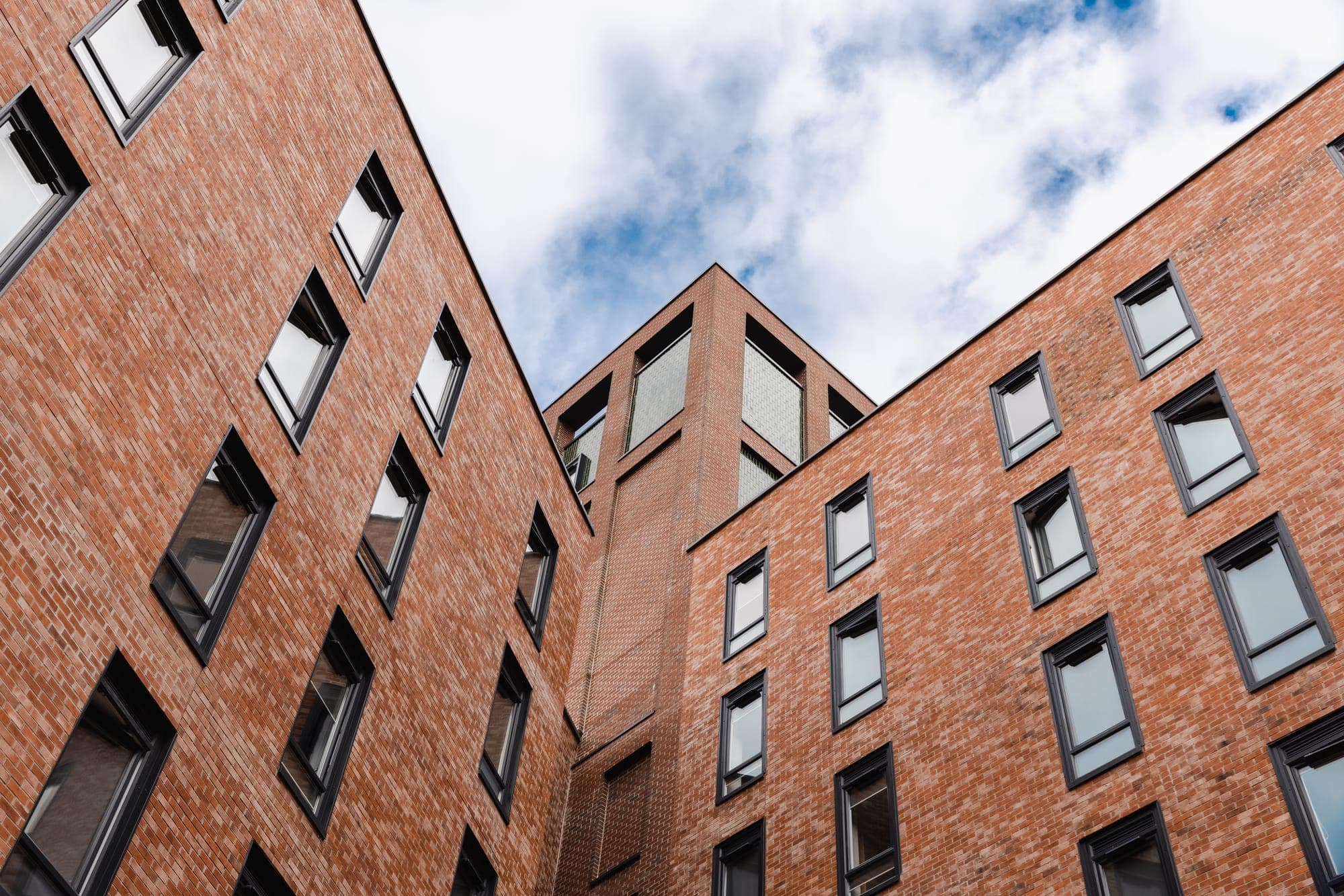 The brick facade of Globe Works looking up towards the sky
