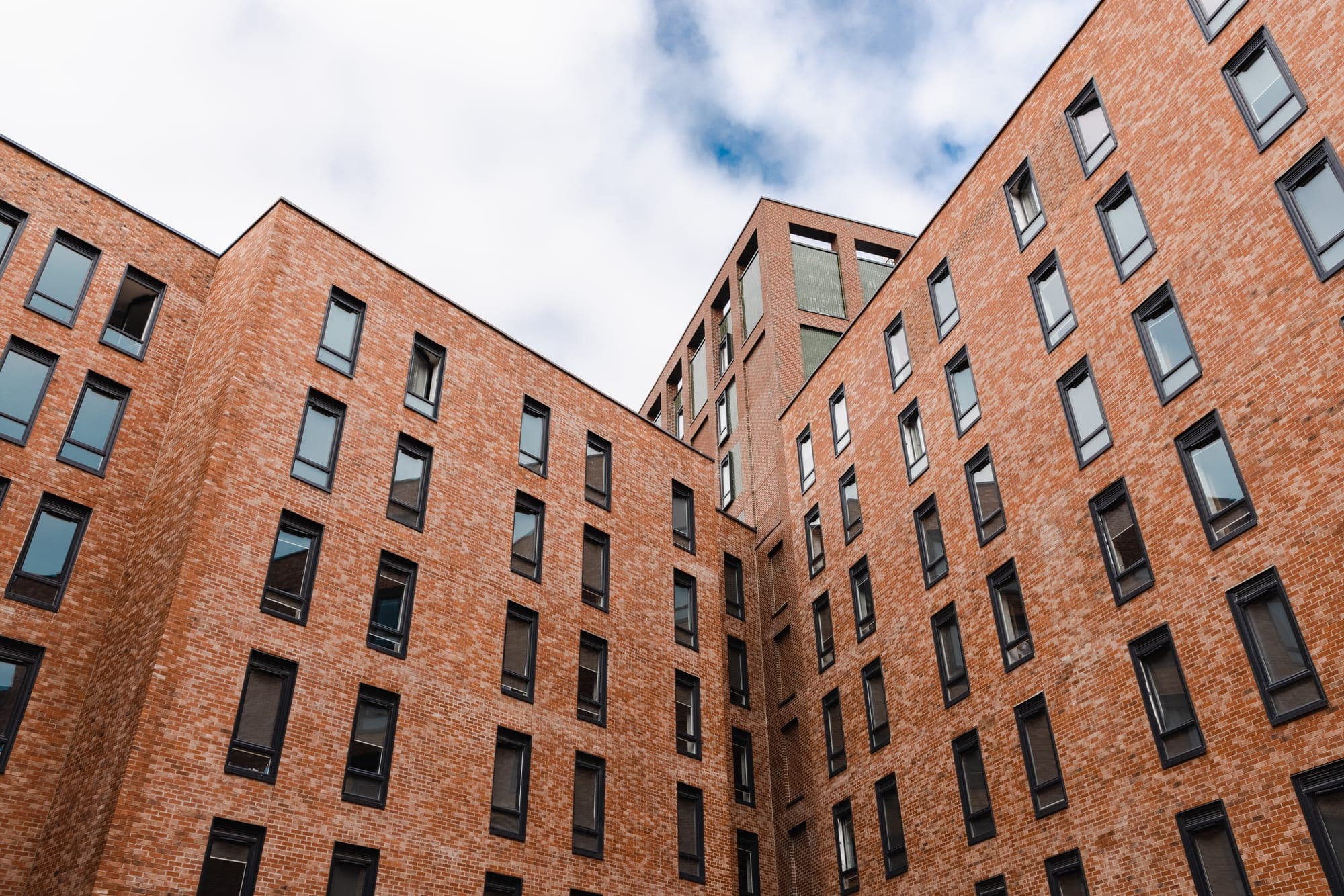 The brick facade of Globe Works rising above the courtyard