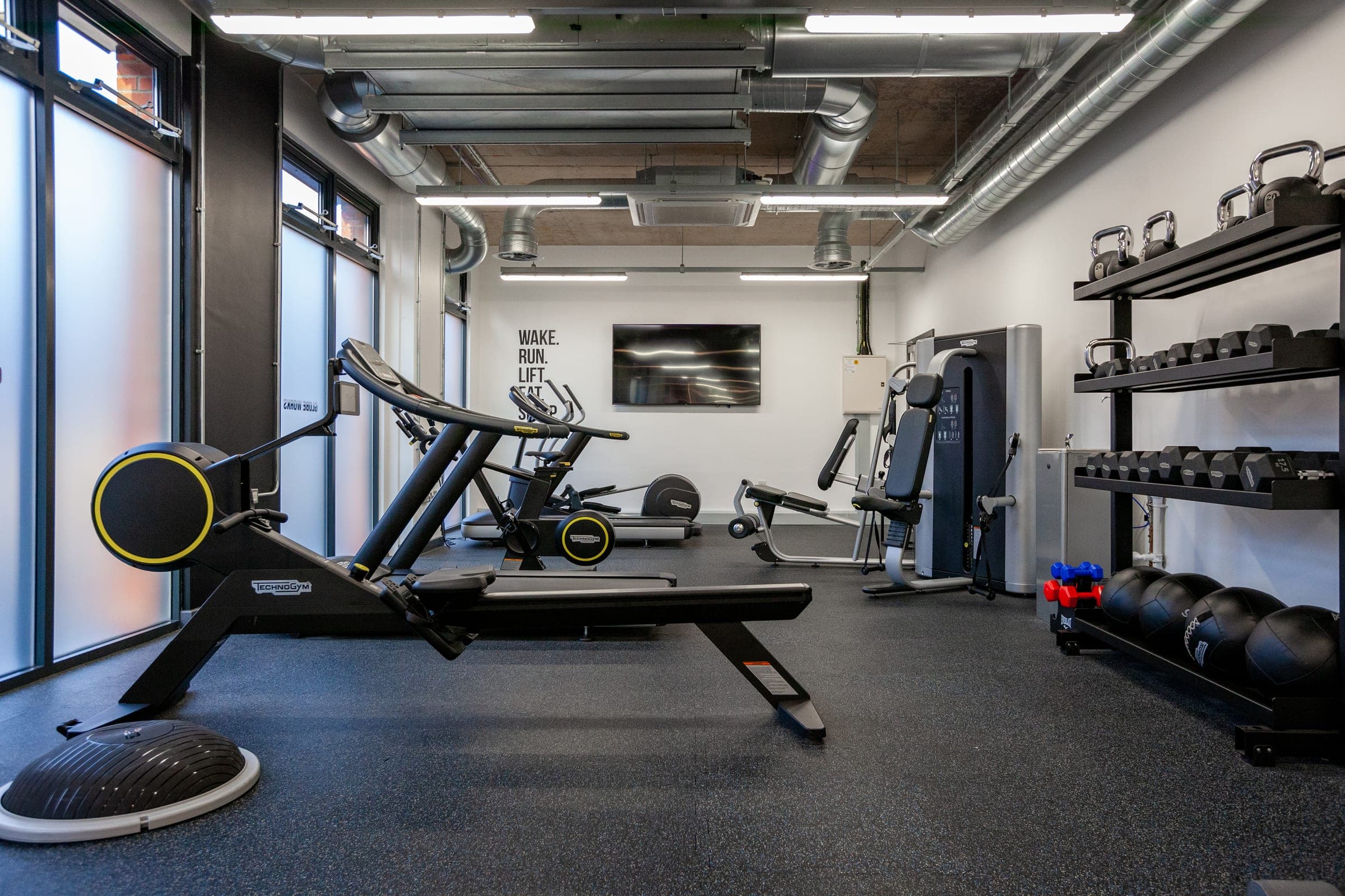 Residents' gym at Globe Works with treadmills, a rower and free weights